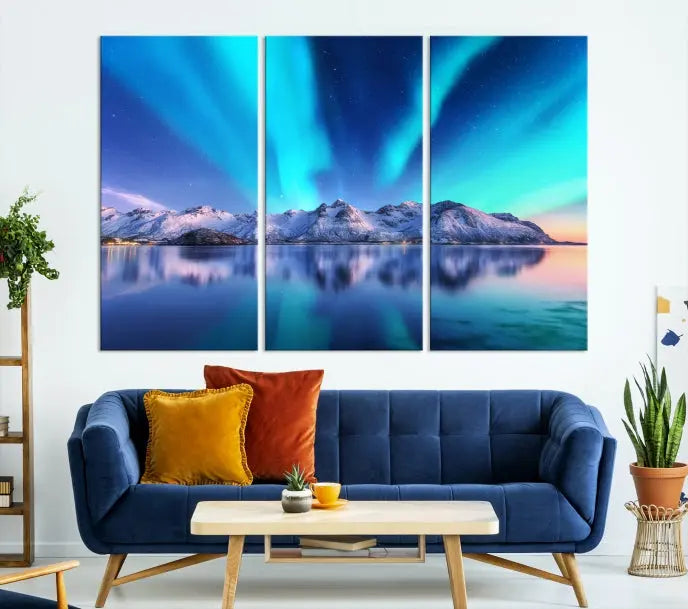 The room features the "Northern Lights above Mountain Wall Art Canvas Print," showcasing a triptych of the aurora borealis over snowy mountains and a lake. Professionally crafted frames on museum-quality canvases are highlighted in the modern decor.