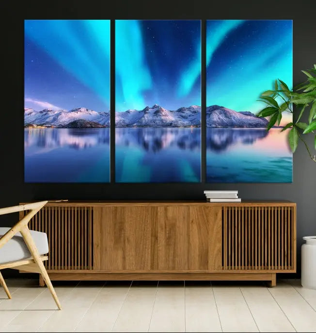 The room features the "Northern Lights above Mountain Wall Art Canvas Print," showcasing a triptych of the aurora borealis over snowy mountains and a lake. Professionally crafted frames on museum-quality canvases are highlighted in the modern decor.