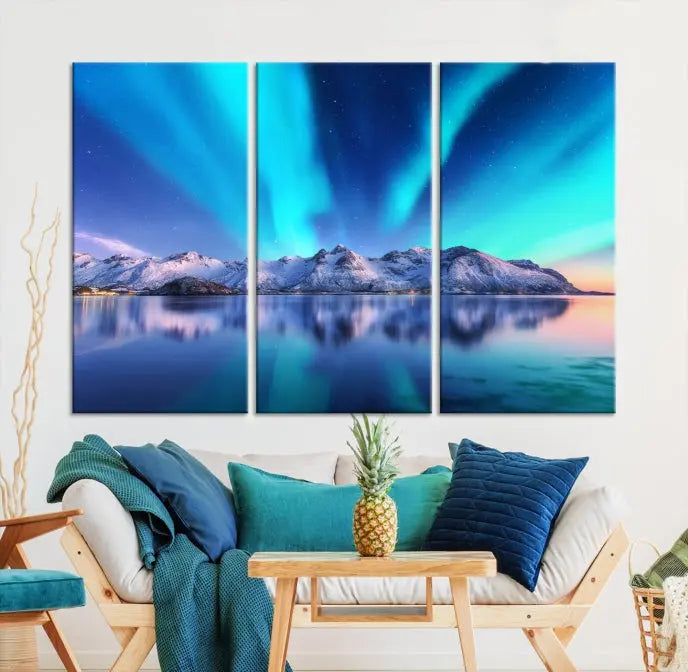 The room features the "Northern Lights above Mountain Wall Art Canvas Print," showcasing a triptych of the aurora borealis over snowy mountains and a lake. Professionally crafted frames on museum-quality canvases are highlighted in the modern decor.