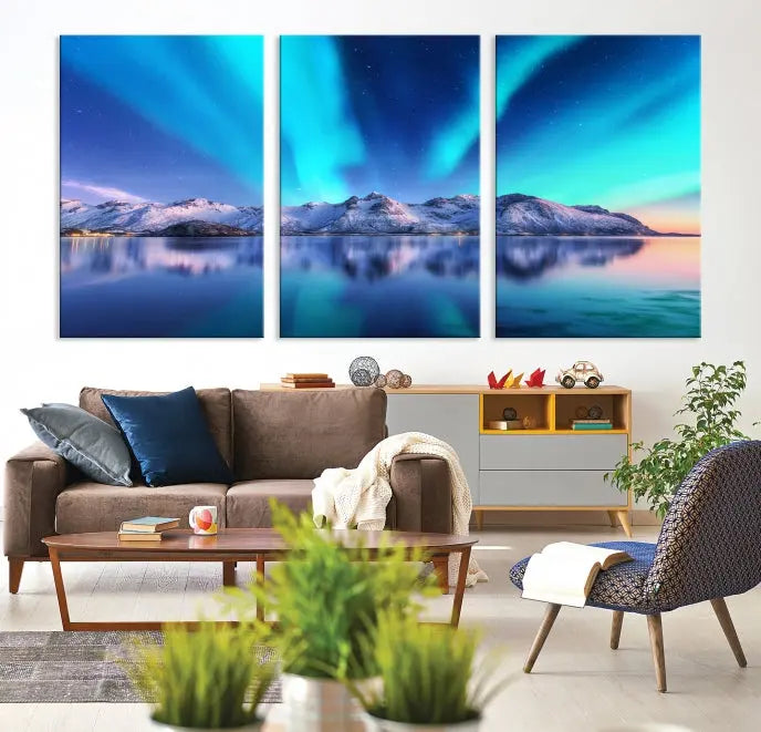 The room features the "Northern Lights above Mountain Wall Art Canvas Print," showcasing a triptych of the aurora borealis over snowy mountains and a lake. Professionally crafted frames on museum-quality canvases are highlighted in the modern decor.