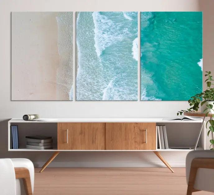 The space above the dark blue sofa is beautifully adorned with the Ocean Aerial Wall Art Canvas Print, featuring a breathtaking aerial beach view spread across five panels. Crafted on gallery-wrapped, museum-quality canvas with a UV-protective coating, it creates an impressive visual display.