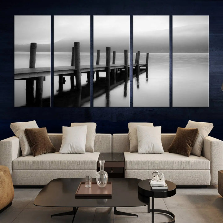 The "Ocean Beach Canvas Wall Art" is a black-and-white triptych depicting a serene dock over water.