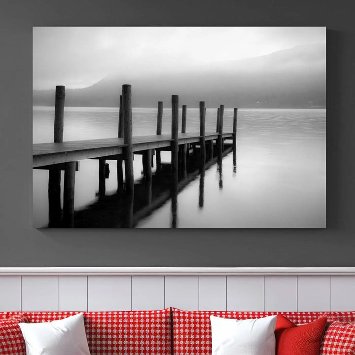 The "Ocean Beach Canvas Wall Art" is a black-and-white triptych depicting a serene dock over water.