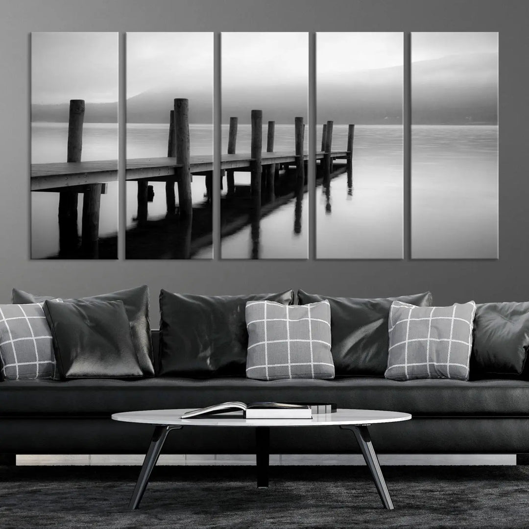 The "Ocean Beach Canvas Wall Art" is a black-and-white triptych depicting a serene dock over water.