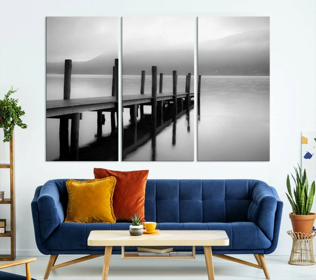 The "Ocean Beach Canvas Wall Art" is a black-and-white triptych depicting a serene dock over water.