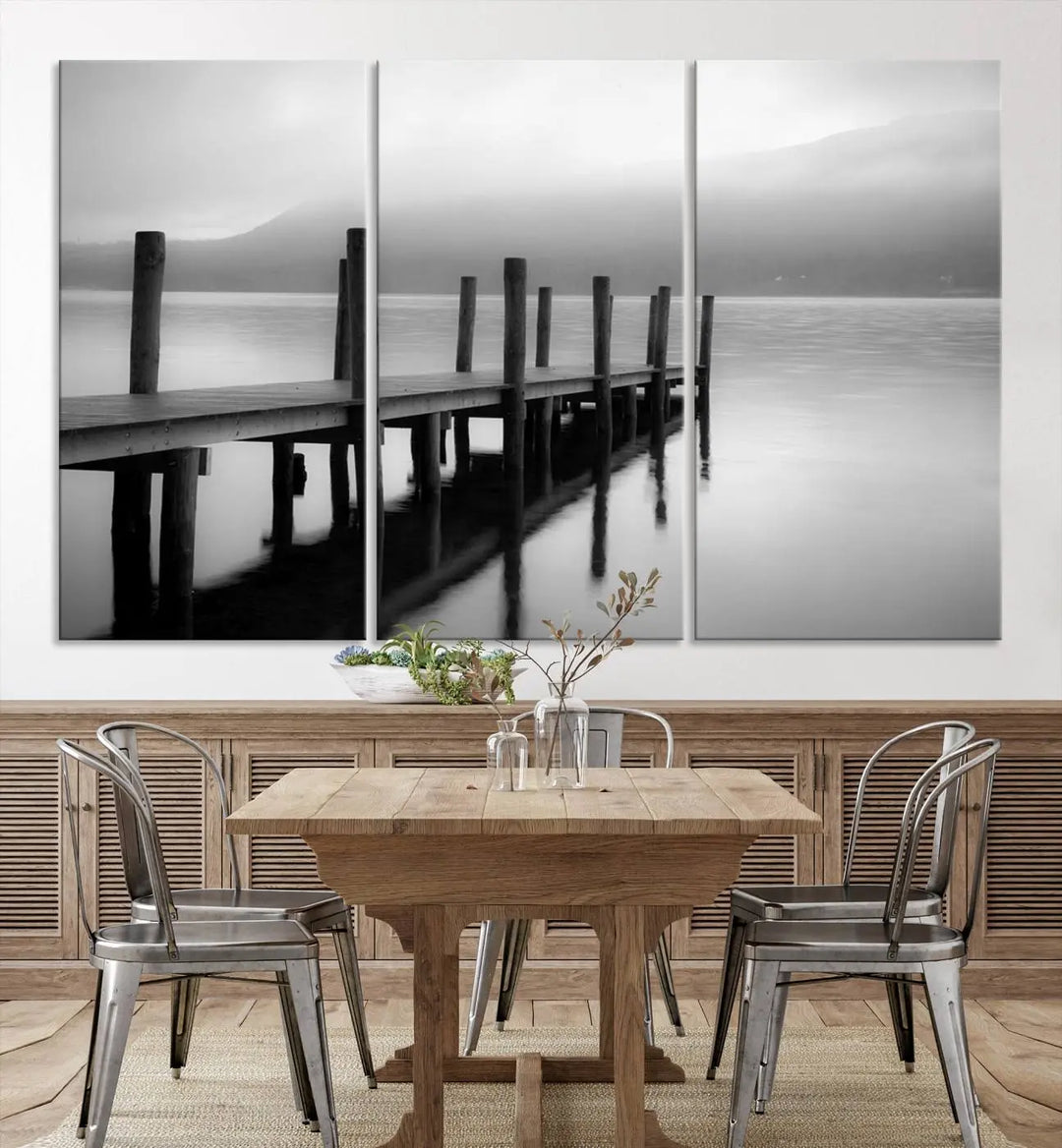 The "Ocean Beach Canvas Wall Art" is a black-and-white triptych depicting a serene dock over water.