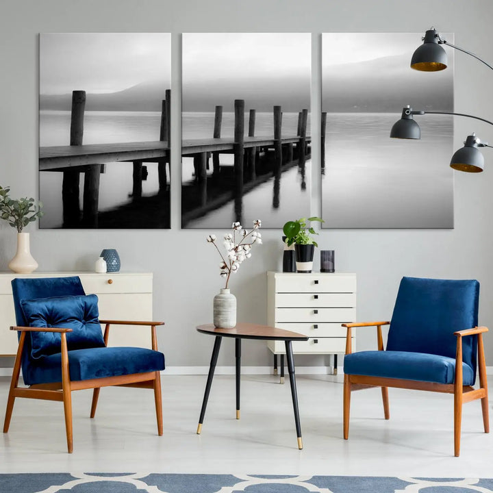 The "Ocean Beach Canvas Wall Art" is a black-and-white triptych depicting a serene dock over water.