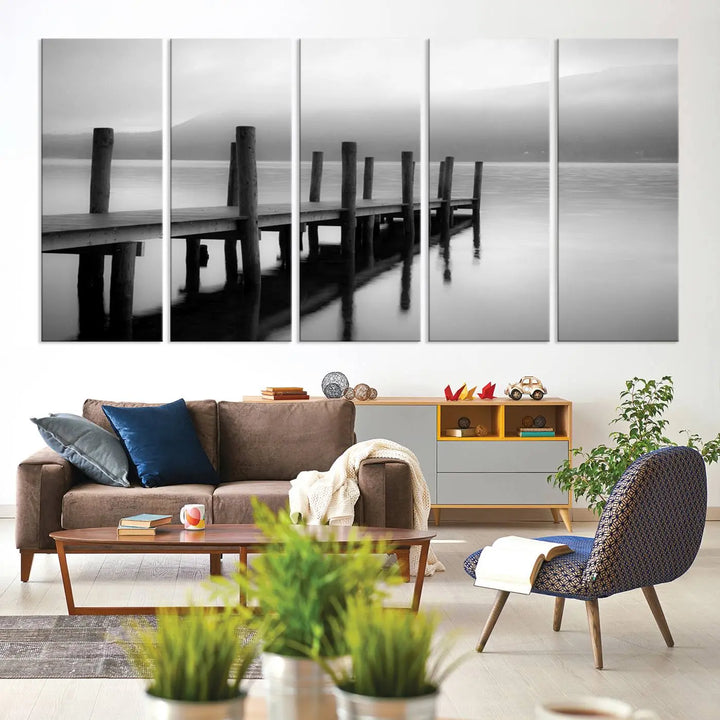 The "Ocean Beach Canvas Wall Art" is a black-and-white triptych depicting a serene dock over water.