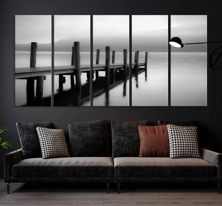 The "Ocean Beach Canvas Wall Art" is a black-and-white triptych depicting a serene dock over water.