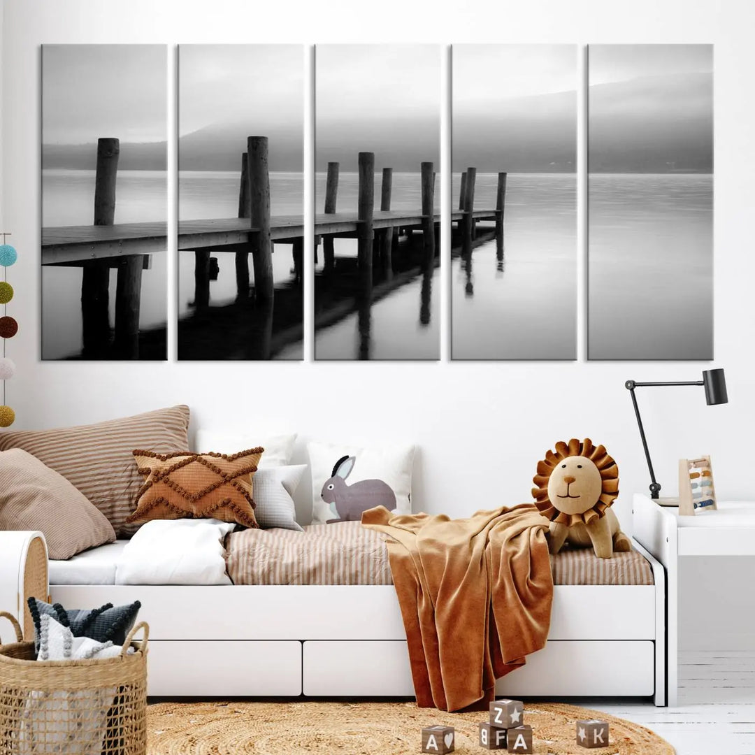 The "Ocean Beach Canvas Wall Art" is a black-and-white triptych depicting a serene dock over water.