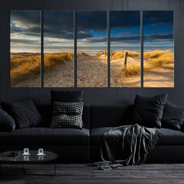 The Ocean Beach Dark Clouds Wall Art Canvas Print is a breathtaking triptych depicting a sandy beach path with tall grasses under an intense cloudy sky. It is crafted on museum-quality canvas with UV protection.