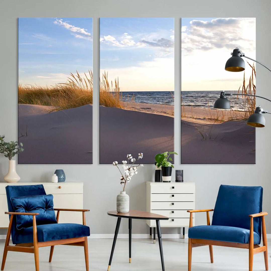 The living room showcases the Ocean Beach Wall Art Canvas Print Sunset Artwork Print Coastal Wall Art—a triptych wall art featuring a beach scene at sunset. Each museum-quality canvas piece is ready to hang and includes a UV-protective coating to preserve its stunning beauty.