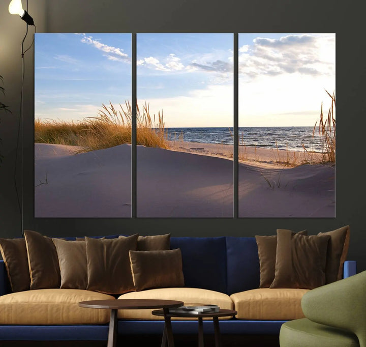 The living room showcases the Ocean Beach Wall Art Canvas Print Sunset Artwork Print Coastal Wall Art—a triptych wall art featuring a beach scene at sunset. Each museum-quality canvas piece is ready to hang and includes a UV-protective coating to preserve its stunning beauty.