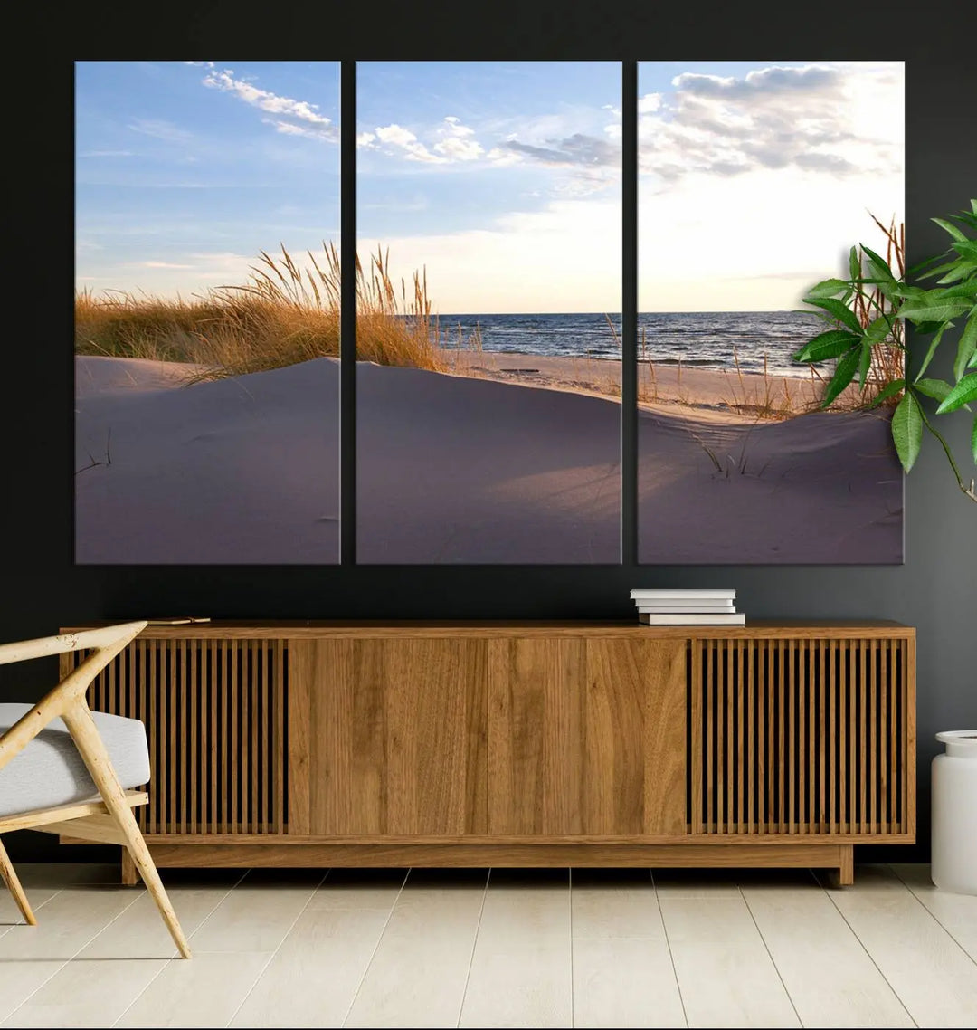 The living room showcases the Ocean Beach Wall Art Canvas Print Sunset Artwork Print Coastal Wall Art—a triptych wall art featuring a beach scene at sunset. Each museum-quality canvas piece is ready to hang and includes a UV-protective coating to preserve its stunning beauty.