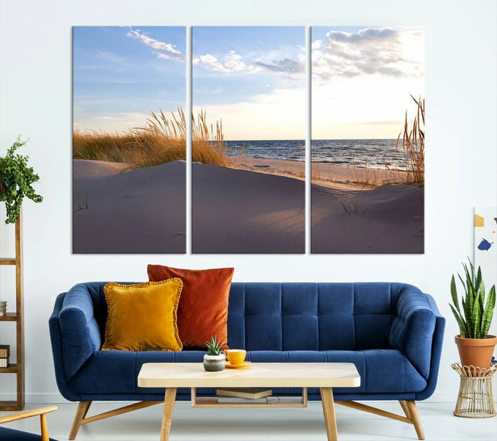 The living room showcases the Ocean Beach Wall Art Canvas Print Sunset Artwork Print Coastal Wall Art—a triptych wall art featuring a beach scene at sunset. Each museum-quality canvas piece is ready to hang and includes a UV-protective coating to preserve its stunning beauty.