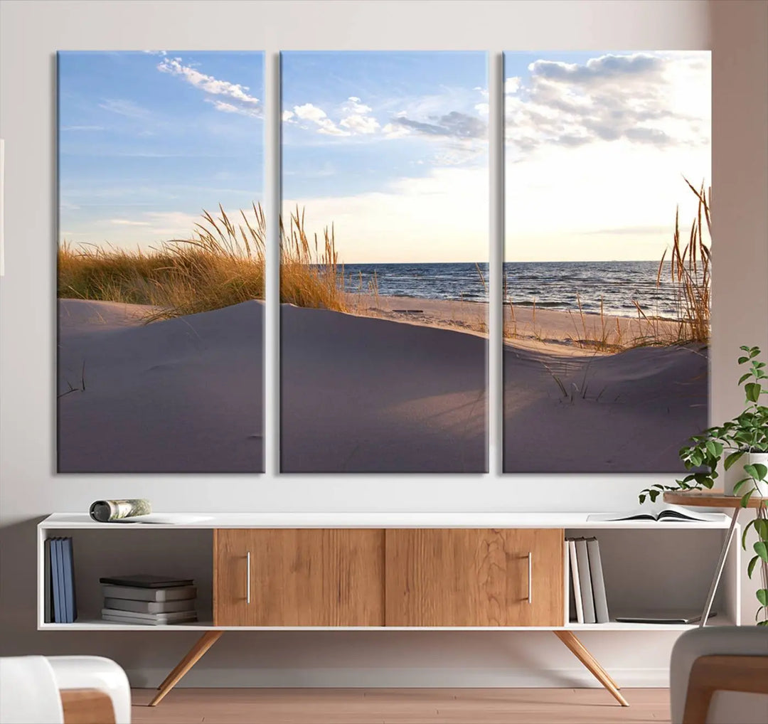 The living room showcases the Ocean Beach Wall Art Canvas Print Sunset Artwork Print Coastal Wall Art—a triptych wall art featuring a beach scene at sunset. Each museum-quality canvas piece is ready to hang and includes a UV-protective coating to preserve its stunning beauty.