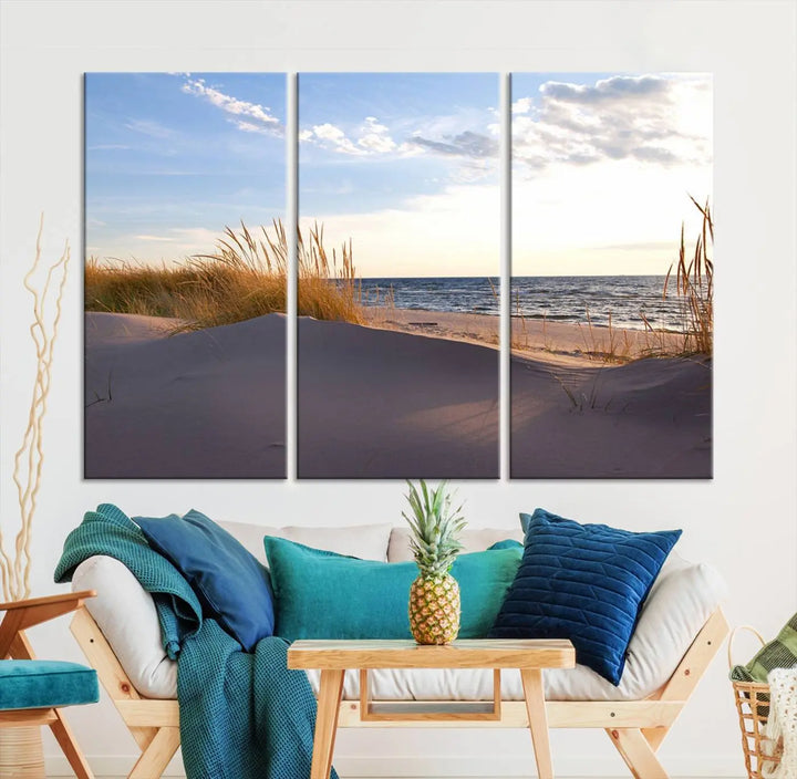 The living room showcases the Ocean Beach Wall Art Canvas Print Sunset Artwork Print Coastal Wall Art—a triptych wall art featuring a beach scene at sunset. Each museum-quality canvas piece is ready to hang and includes a UV-protective coating to preserve its stunning beauty.