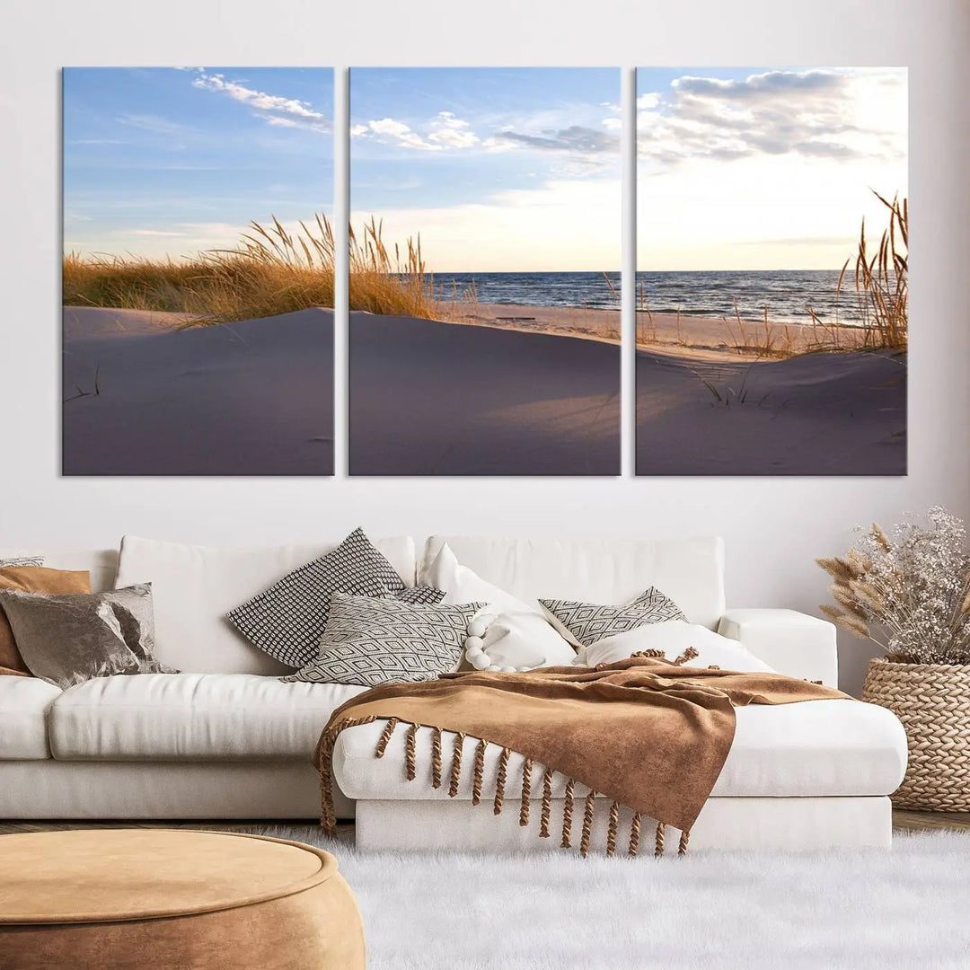 The living room showcases the Ocean Beach Wall Art Canvas Print Sunset Artwork Print Coastal Wall Art—a triptych wall art featuring a beach scene at sunset. Each museum-quality canvas piece is ready to hang and includes a UV-protective coating to preserve its stunning beauty.