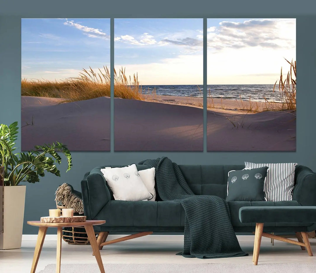 The living room showcases the Ocean Beach Wall Art Canvas Print Sunset Artwork Print Coastal Wall Art—a triptych wall art featuring a beach scene at sunset. Each museum-quality canvas piece is ready to hang and includes a UV-protective coating to preserve its stunning beauty.