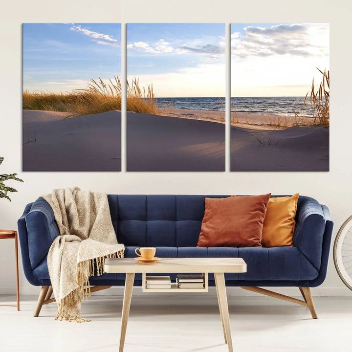 The living room showcases the Ocean Beach Wall Art Canvas Print Sunset Artwork Print Coastal Wall Art—a triptych wall art featuring a beach scene at sunset. Each museum-quality canvas piece is ready to hang and includes a UV-protective coating to preserve its stunning beauty.