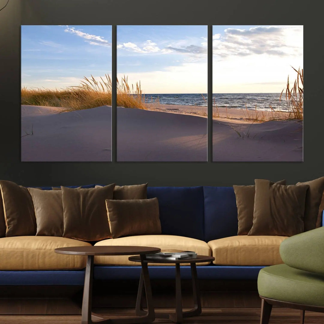 The living room showcases the Ocean Beach Wall Art Canvas Print Sunset Artwork Print Coastal Wall Art—a triptych wall art featuring a beach scene at sunset. Each museum-quality canvas piece is ready to hang and includes a UV-protective coating to preserve its stunning beauty.