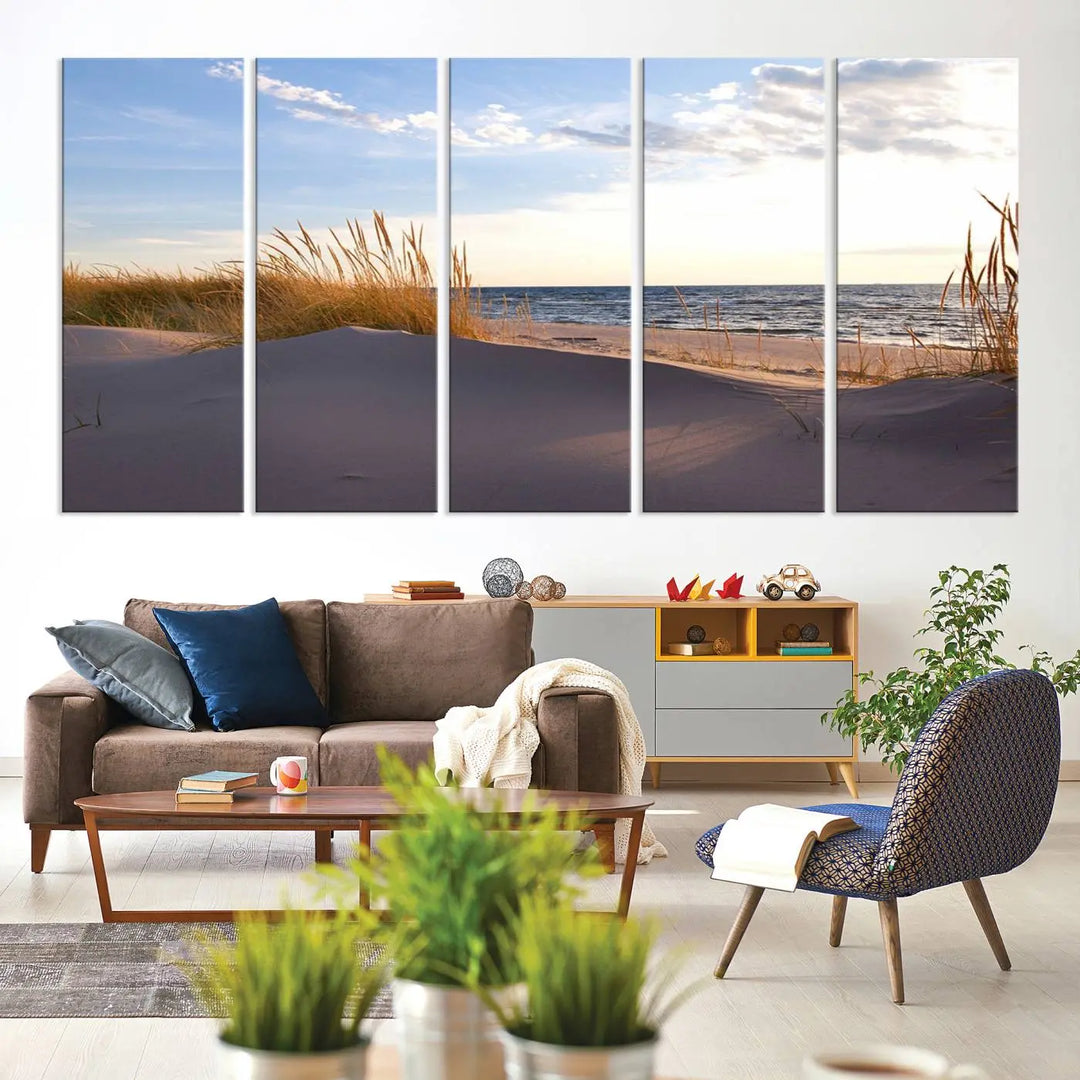 The living room showcases the Ocean Beach Wall Art Canvas Print Sunset Artwork Print Coastal Wall Art—a triptych wall art featuring a beach scene at sunset. Each museum-quality canvas piece is ready to hang and includes a UV-protective coating to preserve its stunning beauty.