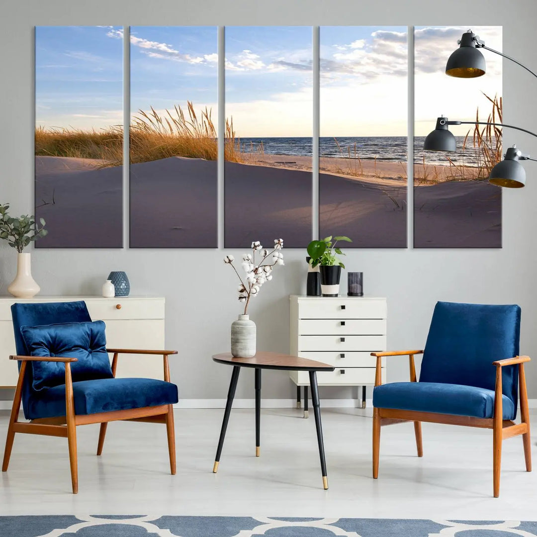 The living room showcases the Ocean Beach Wall Art Canvas Print Sunset Artwork Print Coastal Wall Art—a triptych wall art featuring a beach scene at sunset. Each museum-quality canvas piece is ready to hang and includes a UV-protective coating to preserve its stunning beauty.