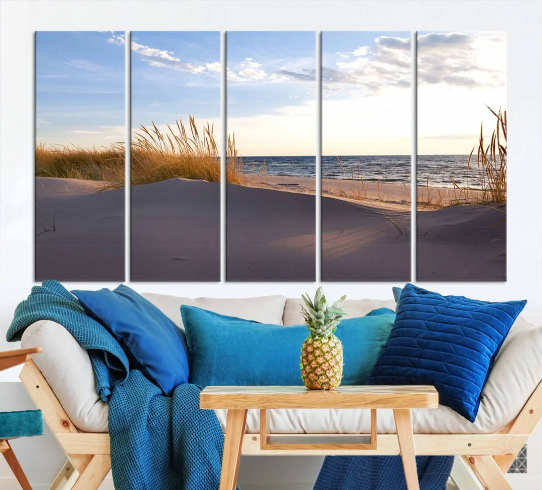 The living room showcases the Ocean Beach Wall Art Canvas Print Sunset Artwork Print Coastal Wall Art—a triptych wall art featuring a beach scene at sunset. Each museum-quality canvas piece is ready to hang and includes a UV-protective coating to preserve its stunning beauty.