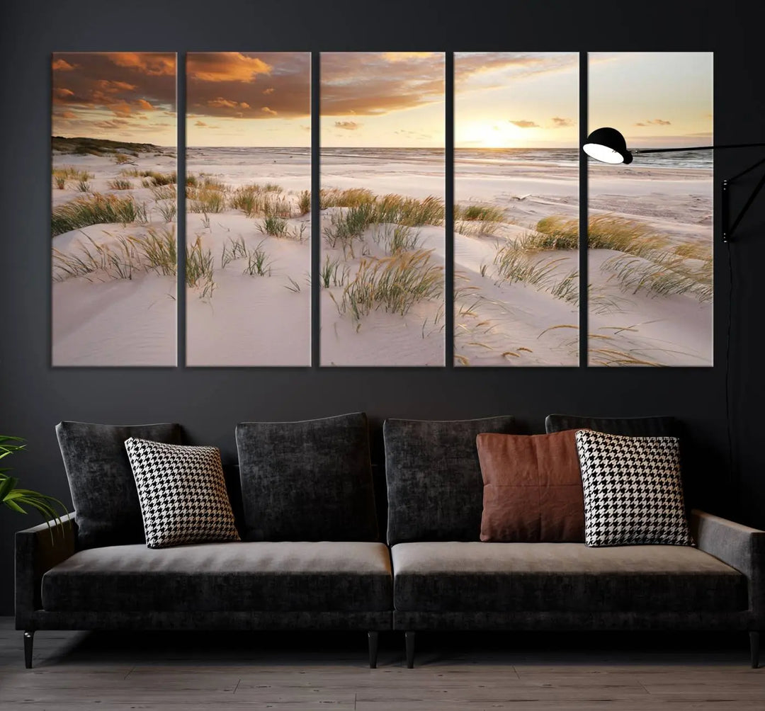 A triptych of the Ocean Beach Wall Art Canvas Print Sunset Artwork Print Coastal Wall Art showcases a serene beach landscape with sand dunes and grasses, gallery wrapped on museum-quality canvas.