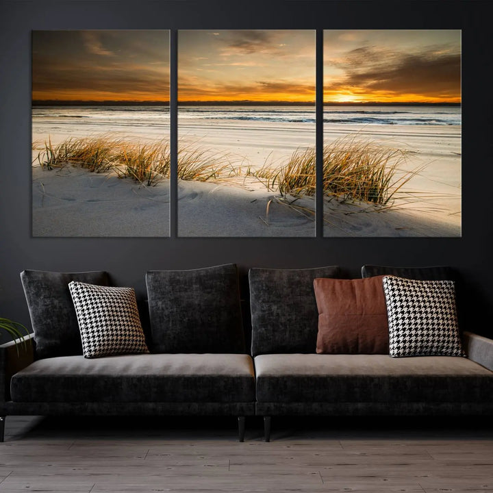 The Ocean Beach Wall Art Canvas Print, a captivating triptych showcasing a sunset over the beach with grass, hangs gracefully. These gallery-wrapped, museum-quality canvases boast a UV-protective coating that preserves their vibrant colors and stunning detail for years to come.