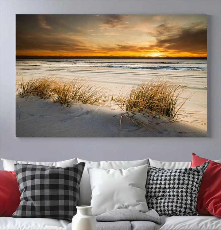 The Ocean Beach Wall Art Canvas Print, a captivating triptych showcasing a sunset over the beach with grass, hangs gracefully. These gallery-wrapped, museum-quality canvases boast a UV-protective coating that preserves their vibrant colors and stunning detail for years to come.