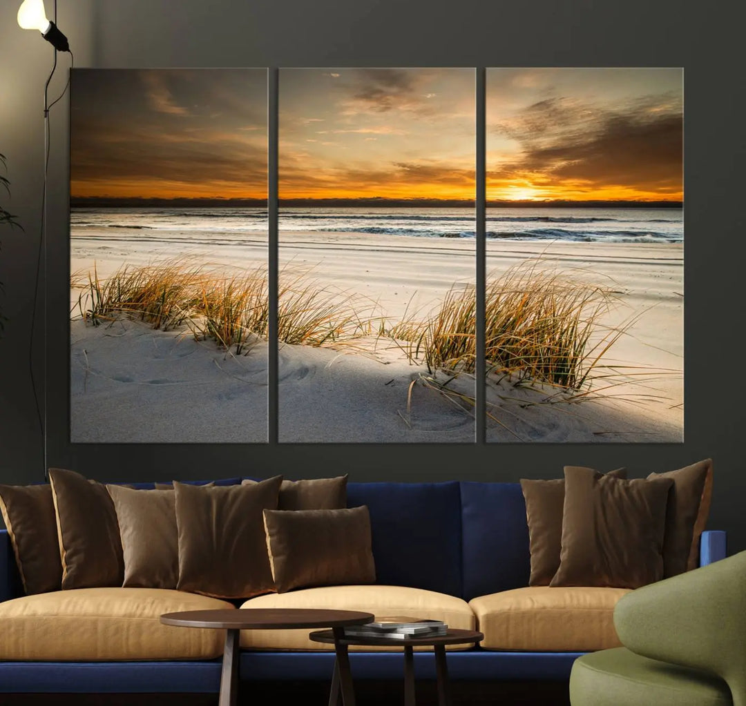 The Ocean Beach Wall Art Canvas Print, a captivating triptych showcasing a sunset over the beach with grass, hangs gracefully. These gallery-wrapped, museum-quality canvases boast a UV-protective coating that preserves their vibrant colors and stunning detail for years to come.