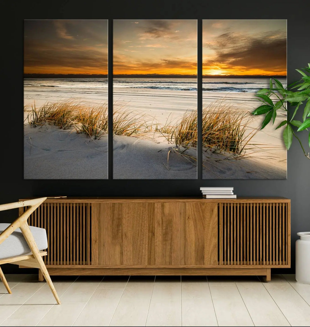 The Ocean Beach Wall Art Canvas Print, a captivating triptych showcasing a sunset over the beach with grass, hangs gracefully. These gallery-wrapped, museum-quality canvases boast a UV-protective coating that preserves their vibrant colors and stunning detail for years to come.