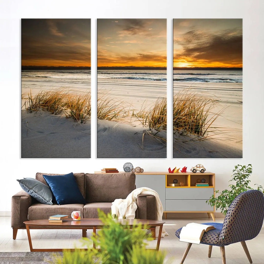 The Ocean Beach Wall Art Canvas Print, a captivating triptych showcasing a sunset over the beach with grass, hangs gracefully. These gallery-wrapped, museum-quality canvases boast a UV-protective coating that preserves their vibrant colors and stunning detail for years to come.