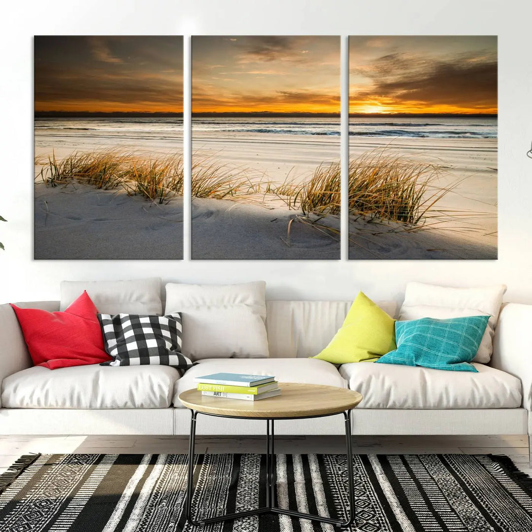 The Ocean Beach Wall Art Canvas Print, a captivating triptych showcasing a sunset over the beach with grass, hangs gracefully. These gallery-wrapped, museum-quality canvases boast a UV-protective coating that preserves their vibrant colors and stunning detail for years to come.