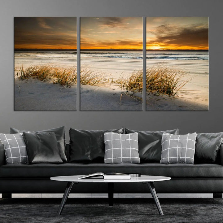 The Ocean Beach Wall Art Canvas Print, a captivating triptych showcasing a sunset over the beach with grass, hangs gracefully. These gallery-wrapped, museum-quality canvases boast a UV-protective coating that preserves their vibrant colors and stunning detail for years to come.