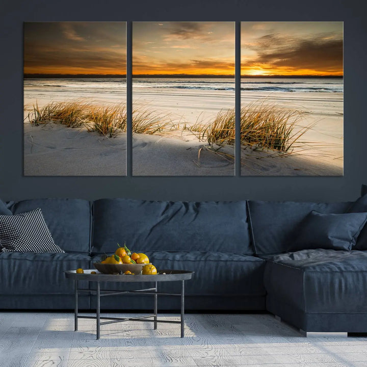 The Ocean Beach Wall Art Canvas Print, a captivating triptych showcasing a sunset over the beach with grass, hangs gracefully. These gallery-wrapped, museum-quality canvases boast a UV-protective coating that preserves their vibrant colors and stunning detail for years to come.