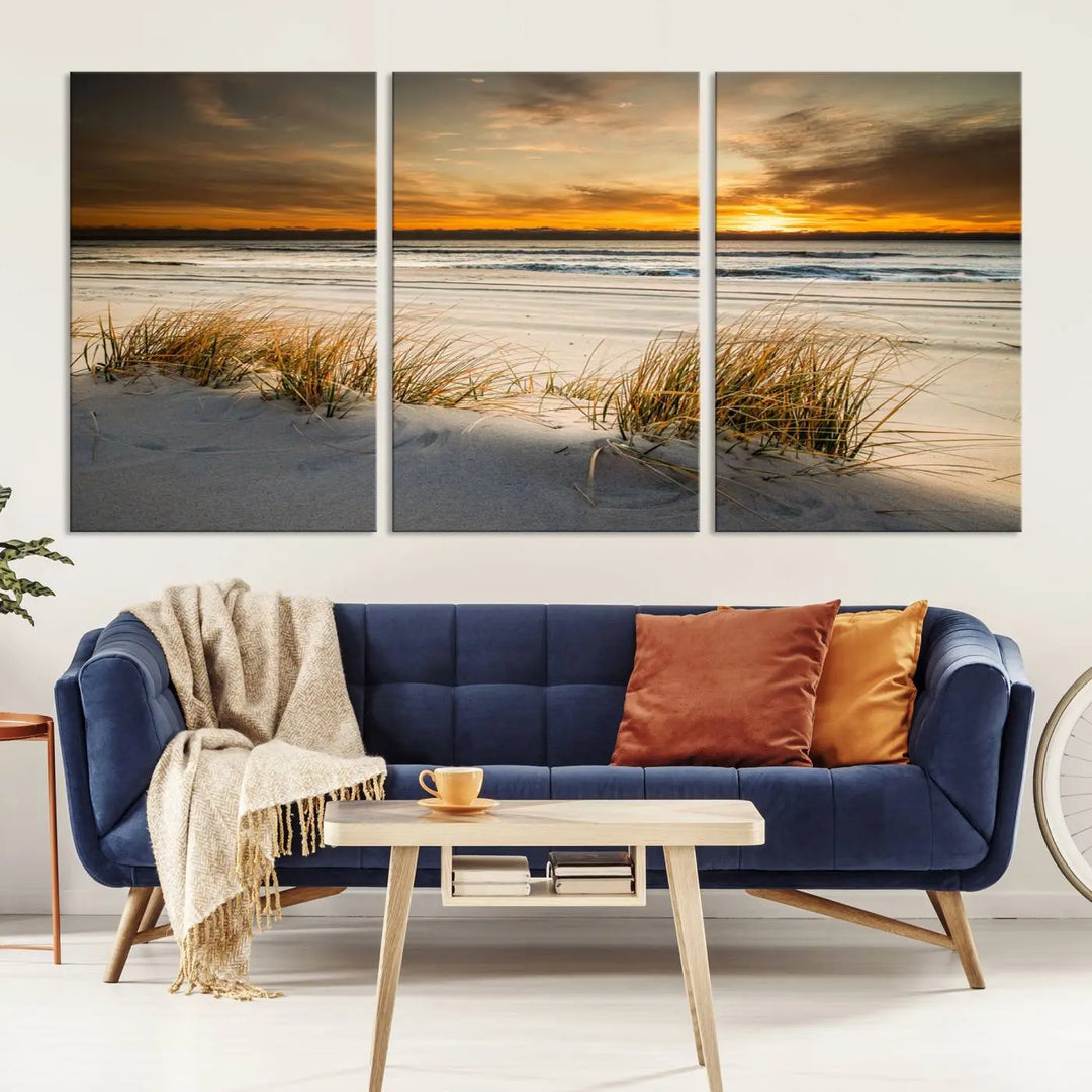 The Ocean Beach Wall Art Canvas Print, a captivating triptych showcasing a sunset over the beach with grass, hangs gracefully. These gallery-wrapped, museum-quality canvases boast a UV-protective coating that preserves their vibrant colors and stunning detail for years to come.