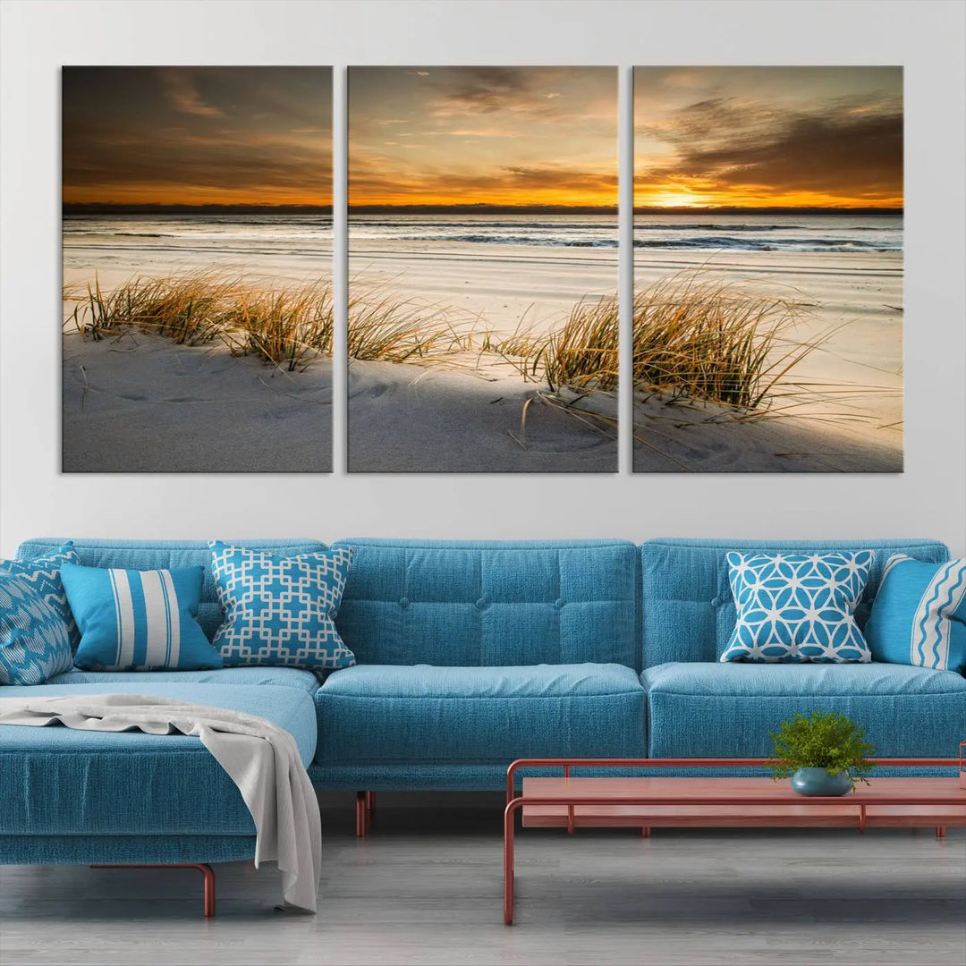 The Ocean Beach Wall Art Canvas Print, a captivating triptych showcasing a sunset over the beach with grass, hangs gracefully. These gallery-wrapped, museum-quality canvases boast a UV-protective coating that preserves their vibrant colors and stunning detail for years to come.