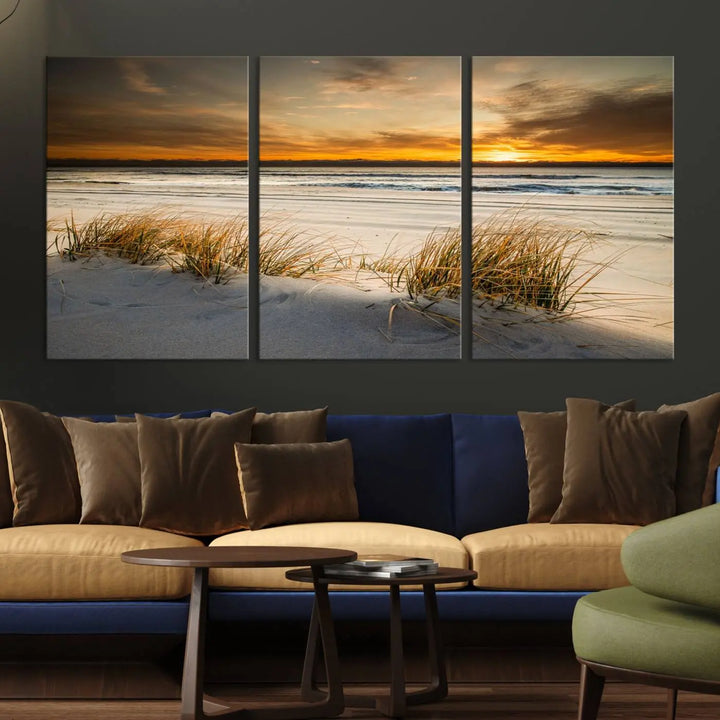 The Ocean Beach Wall Art Canvas Print, a captivating triptych showcasing a sunset over the beach with grass, hangs gracefully. These gallery-wrapped, museum-quality canvases boast a UV-protective coating that preserves their vibrant colors and stunning detail for years to come.