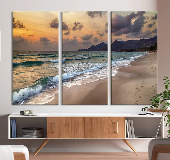 The Ocean Beach Wall Art Canvas Print, a stunning triptych featuring sunset artwork that captures waves and footprints on the sand, beautifully enhances any coastal decor.