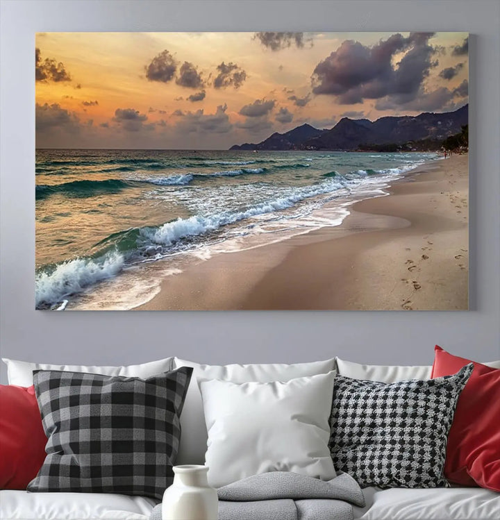 The Ocean Beach Wall Art Canvas Print, a stunning triptych featuring sunset artwork that captures waves and footprints on the sand, beautifully enhances any coastal decor.