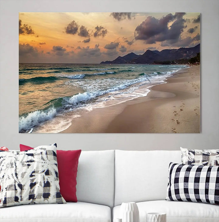 The Ocean Beach Wall Art Canvas Print, a stunning triptych featuring sunset artwork that captures waves and footprints on the sand, beautifully enhances any coastal decor.