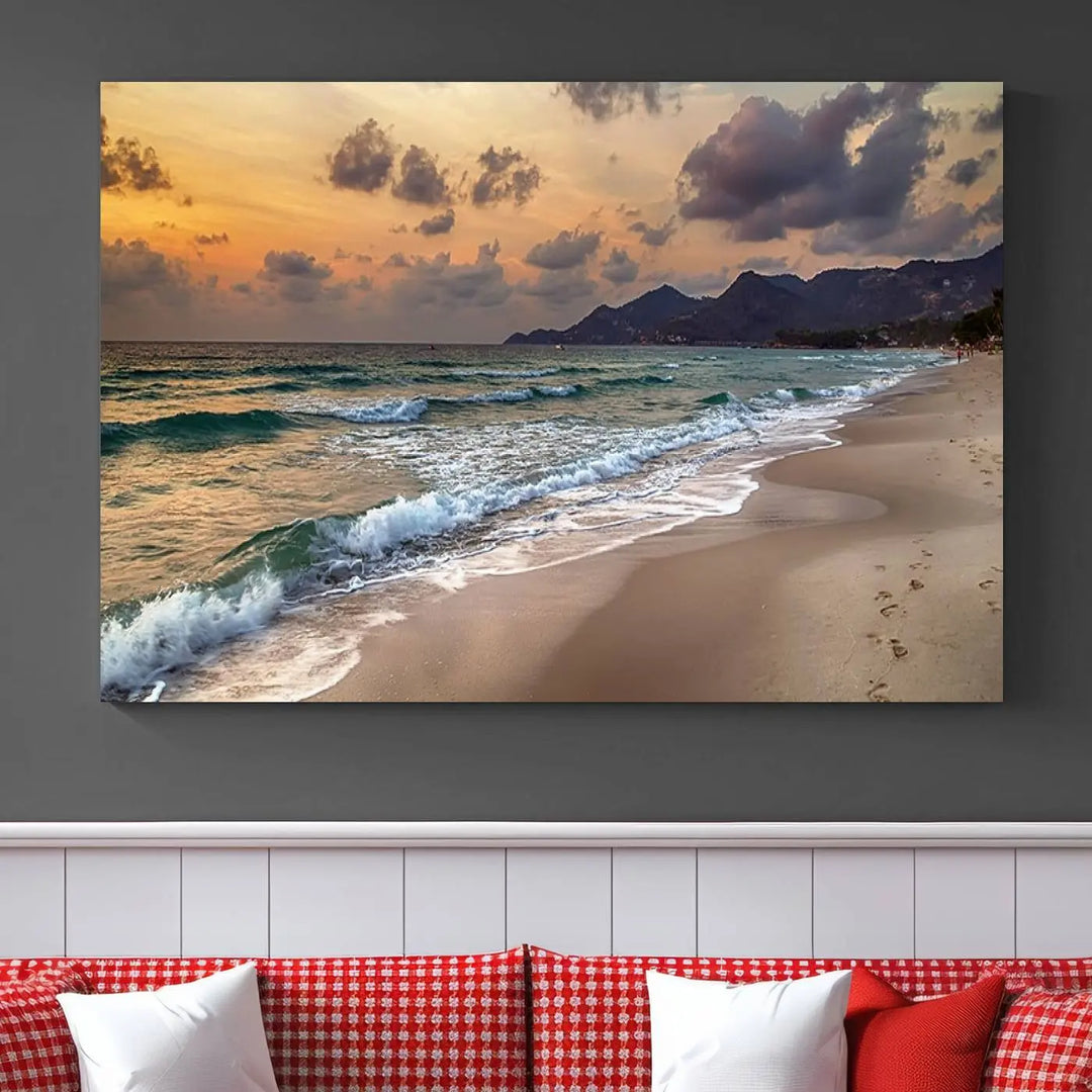 The Ocean Beach Wall Art Canvas Print, a stunning triptych featuring sunset artwork that captures waves and footprints on the sand, beautifully enhances any coastal decor.