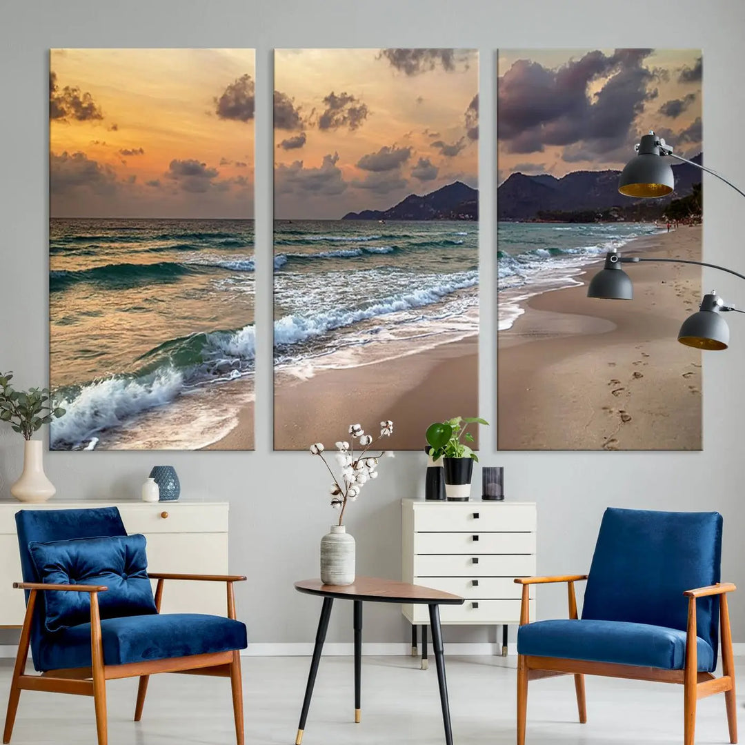 The Ocean Beach Wall Art Canvas Print, a stunning triptych featuring sunset artwork that captures waves and footprints on the sand, beautifully enhances any coastal decor.