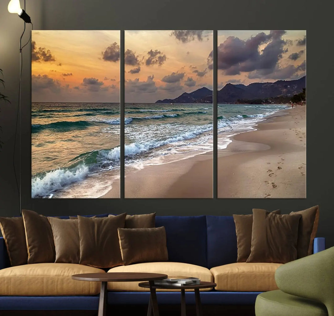 The Ocean Beach Wall Art Canvas Print, a stunning triptych featuring sunset artwork that captures waves and footprints on the sand, beautifully enhances any coastal decor.