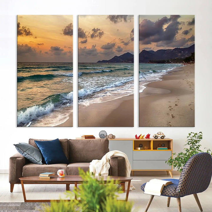 The Ocean Beach Wall Art Canvas Print, a stunning triptych featuring sunset artwork that captures waves and footprints on the sand, beautifully enhances any coastal decor.