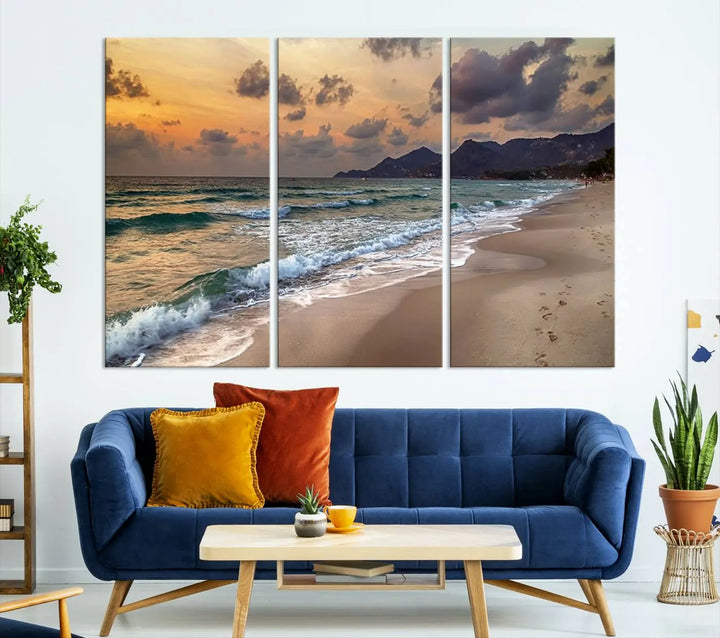 The Ocean Beach Wall Art Canvas Print, a stunning triptych featuring sunset artwork that captures waves and footprints on the sand, beautifully enhances any coastal decor.