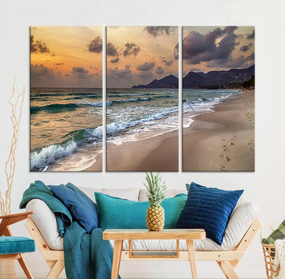 The Ocean Beach Wall Art Canvas Print, a stunning triptych featuring sunset artwork that captures waves and footprints on the sand, beautifully enhances any coastal decor.