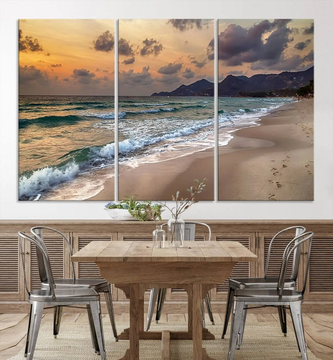 The Ocean Beach Wall Art Canvas Print, a stunning triptych featuring sunset artwork that captures waves and footprints on the sand, beautifully enhances any coastal decor.